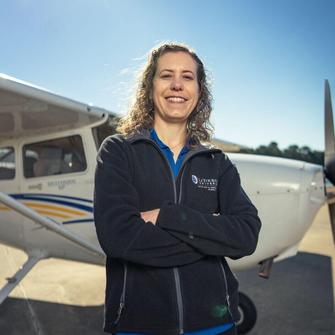 woman in front of plane