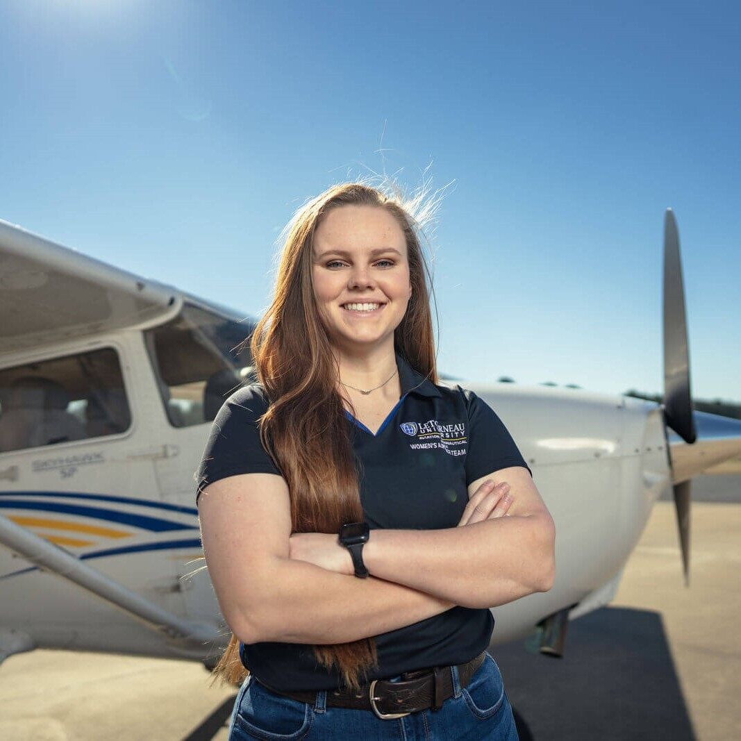 woman in front of plane