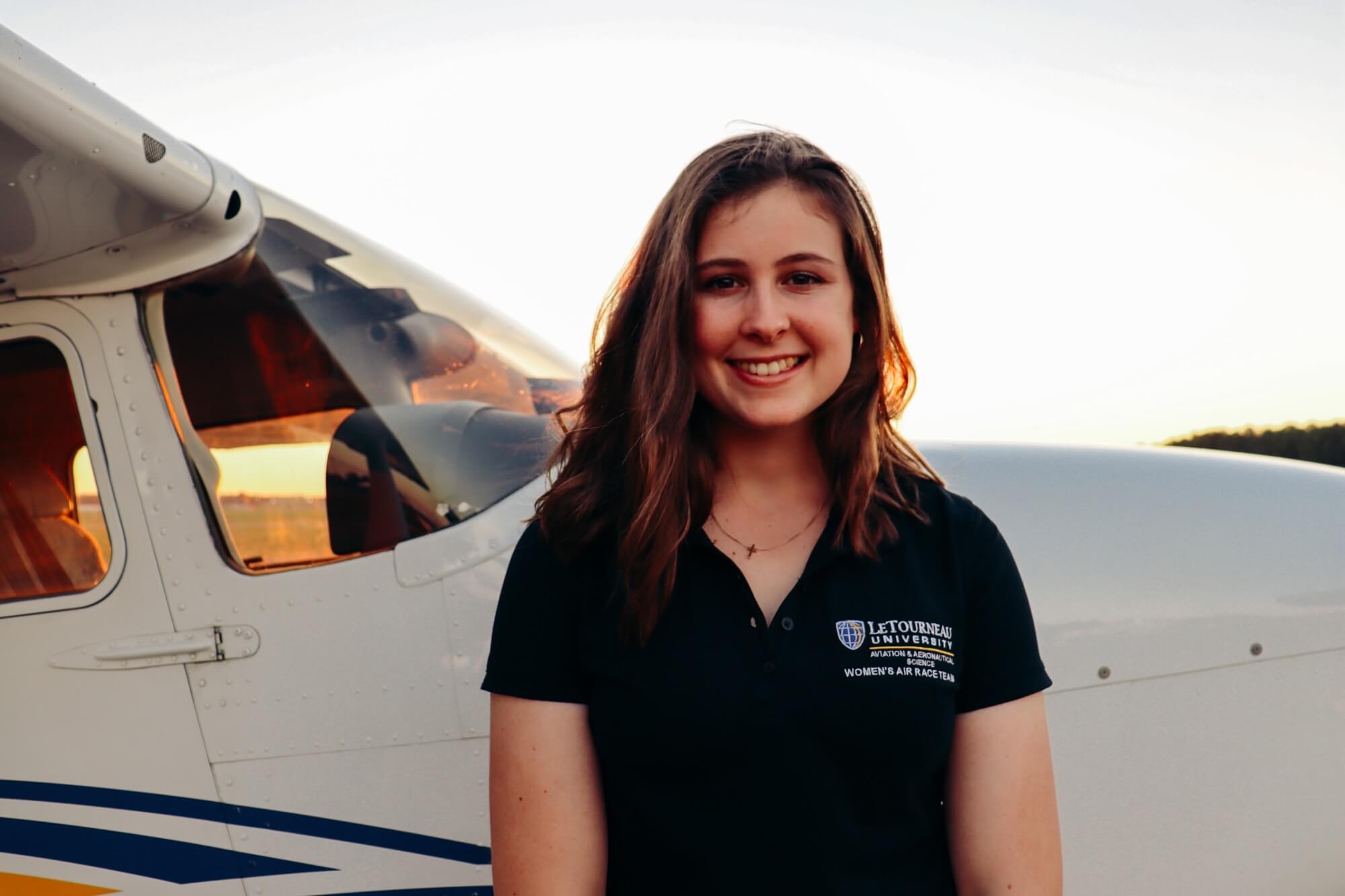 woman in front of a plane