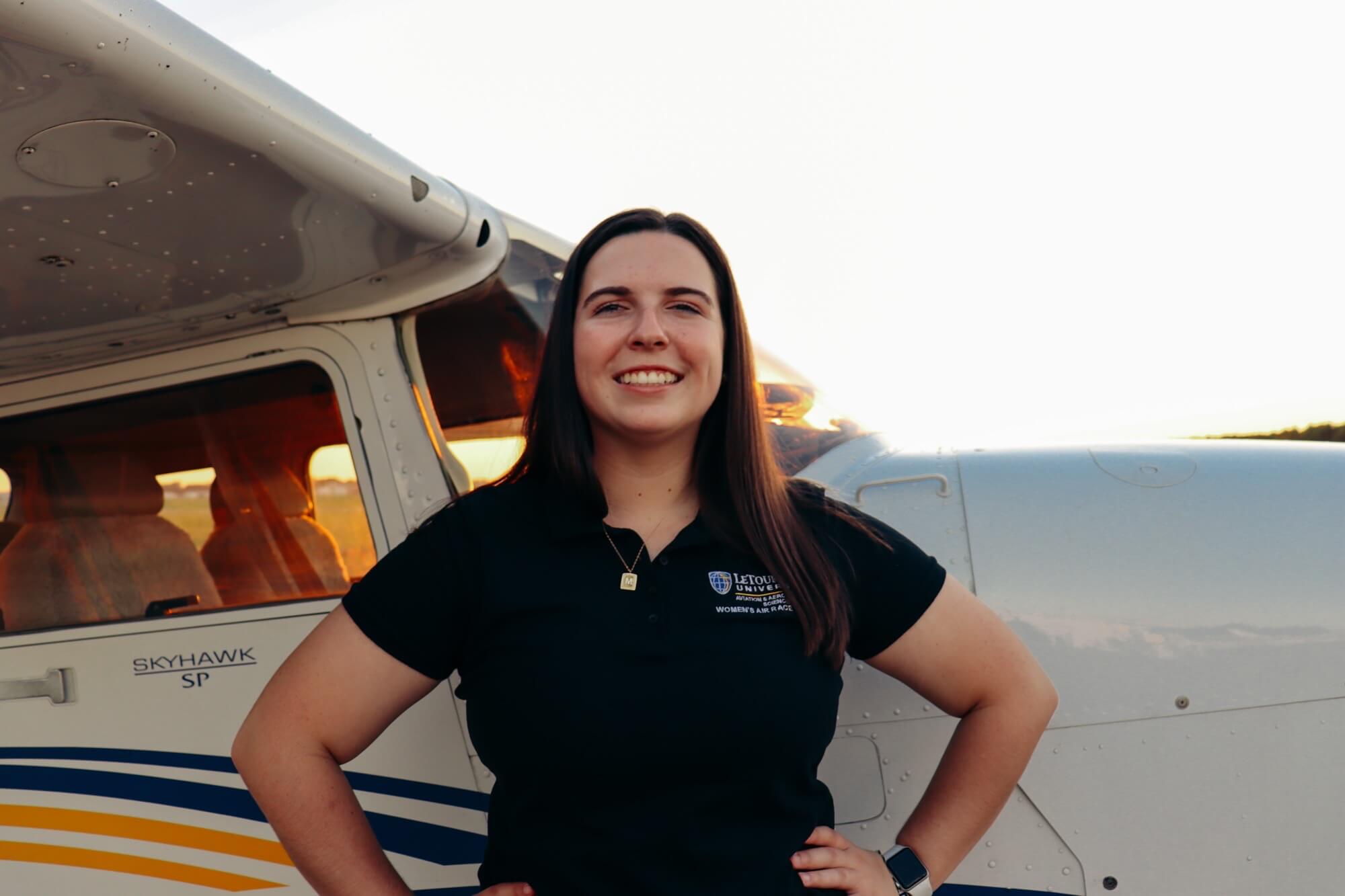 woman in front of plane