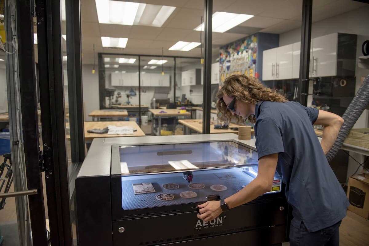 Maker Lab: student using laser cutter