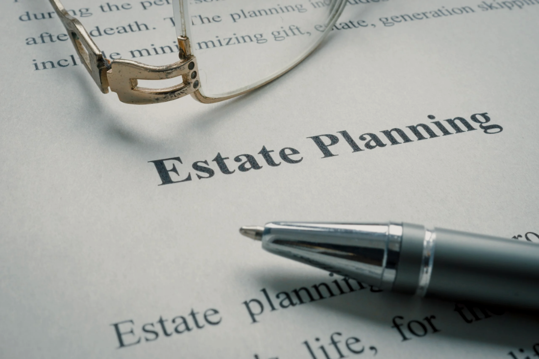 Estate-planning documents, glasses, and a pen