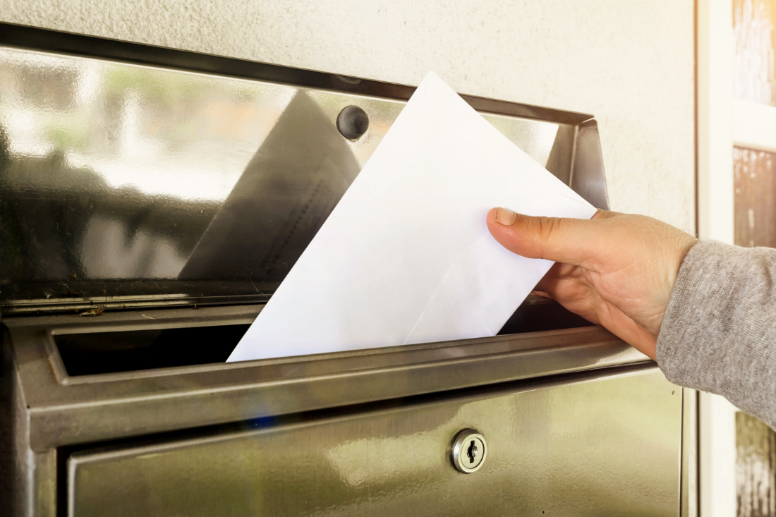 Envelope being placed into a mail slot